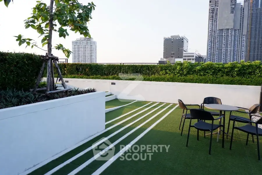 Modern rooftop terrace with stylish seating and city skyline view