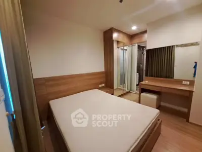 Modern bedroom with wooden accents and mirrored wardrobe in cozy apartment.