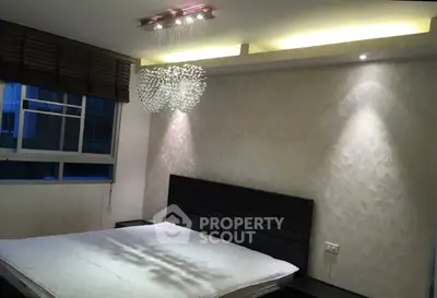 Elegant bedroom with modern chandelier and stylish wallpaper
