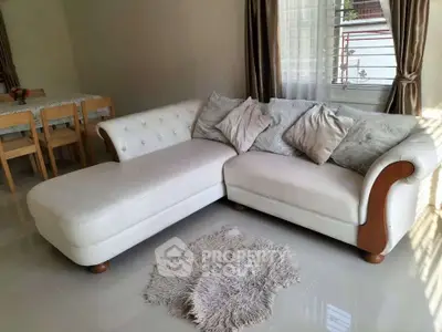 Elegant living room with plush white sectional sofa and cozy decor