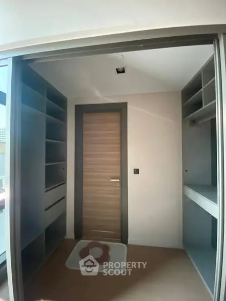 Spacious walk-in closet with modern shelving and natural light.
