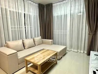 Modern living room with elegant beige sofa and sheer curtains