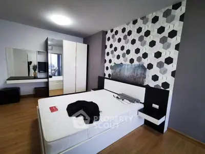 Modern bedroom with geometric accent wall and sleek furniture design