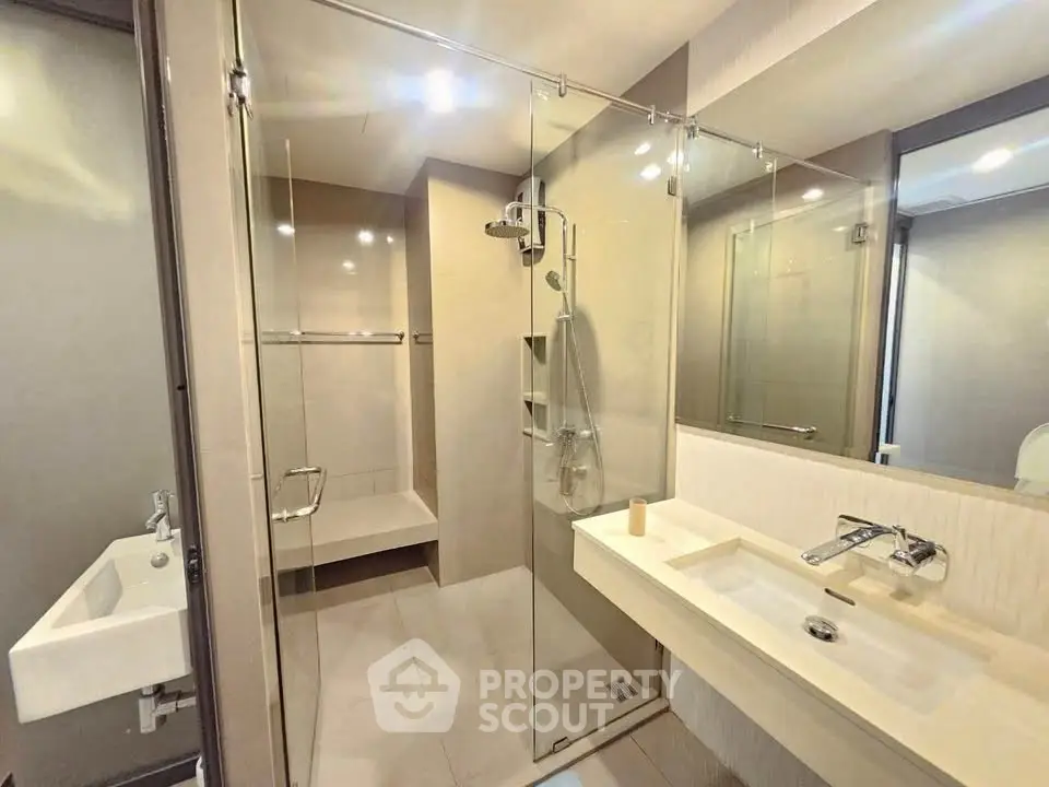 Modern bathroom with glass shower and sleek fixtures