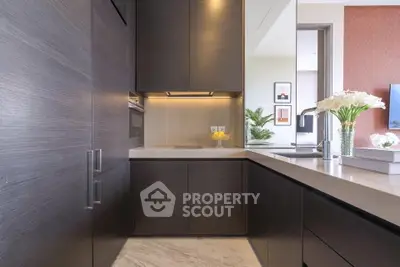 Modern kitchen with sleek cabinetry and elegant countertop in a luxury apartment.