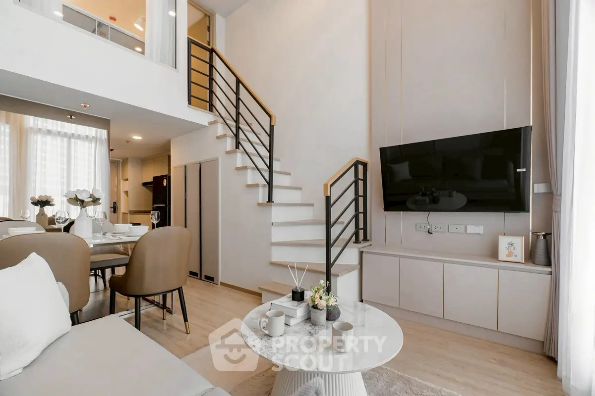 Modern living room with stylish staircase and open dining area in a contemporary apartment.