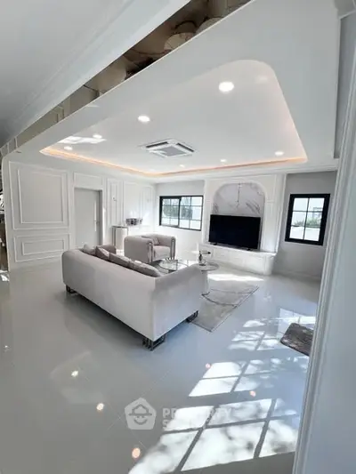 Luxurious modern living room with elegant white decor and large windows