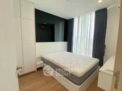 Modern bedroom with large window and minimalist design in a high-rise apartment.