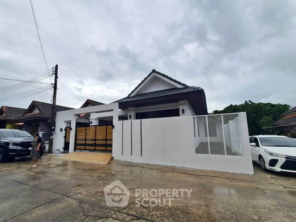 Charming modern house with sleek white facade and spacious driveway in a serene neighborhood.