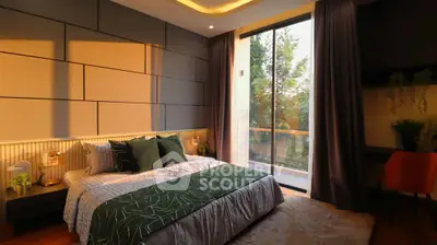 Luxurious bedroom with modern decor and large window overlooking greenery, perfect for relaxation.