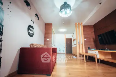 Stylish modern living room with unique wall art and cozy red sofa