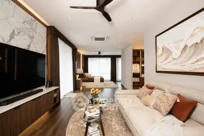 Luxurious open-plan living room with elegant decor and modern amenities, featuring a spacious layout and stylish furnishings.