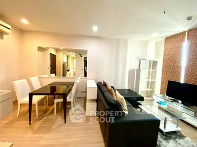 Spacious modern living room with sleek furniture and dining area in open layout.