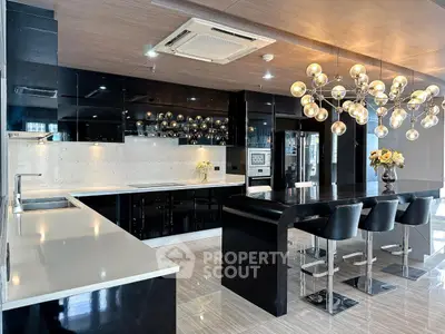 Luxurious modern kitchen with sleek black cabinets and elegant lighting