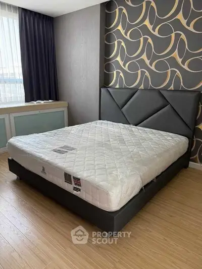 Modern bedroom with stylish wallpaper and comfortable bed