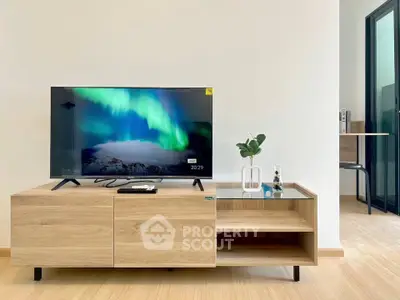 Modern living room with sleek TV stand and vibrant wall art, perfect for contemporary home decor.