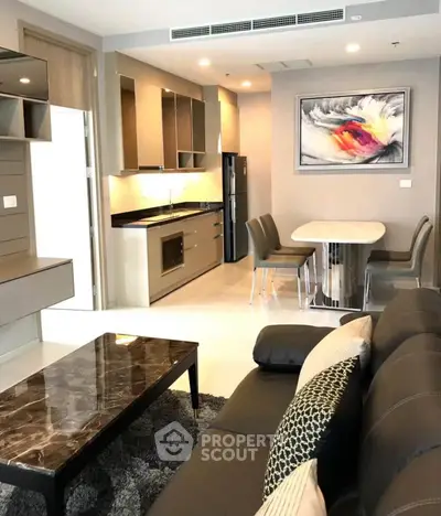 Modern open-plan living room with sleek kitchen and stylish dining area, perfect for contemporary living.