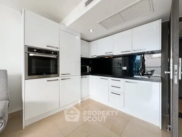Modern kitchen with sleek white cabinets and built-in appliances