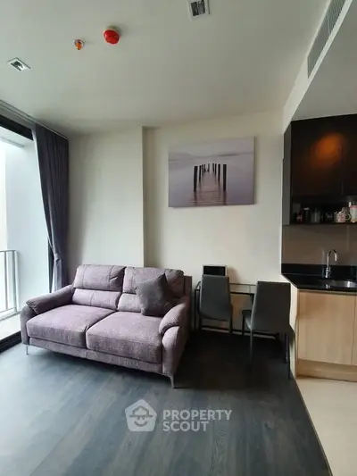 Modern living room with cozy sofa and dining area in stylish apartment
