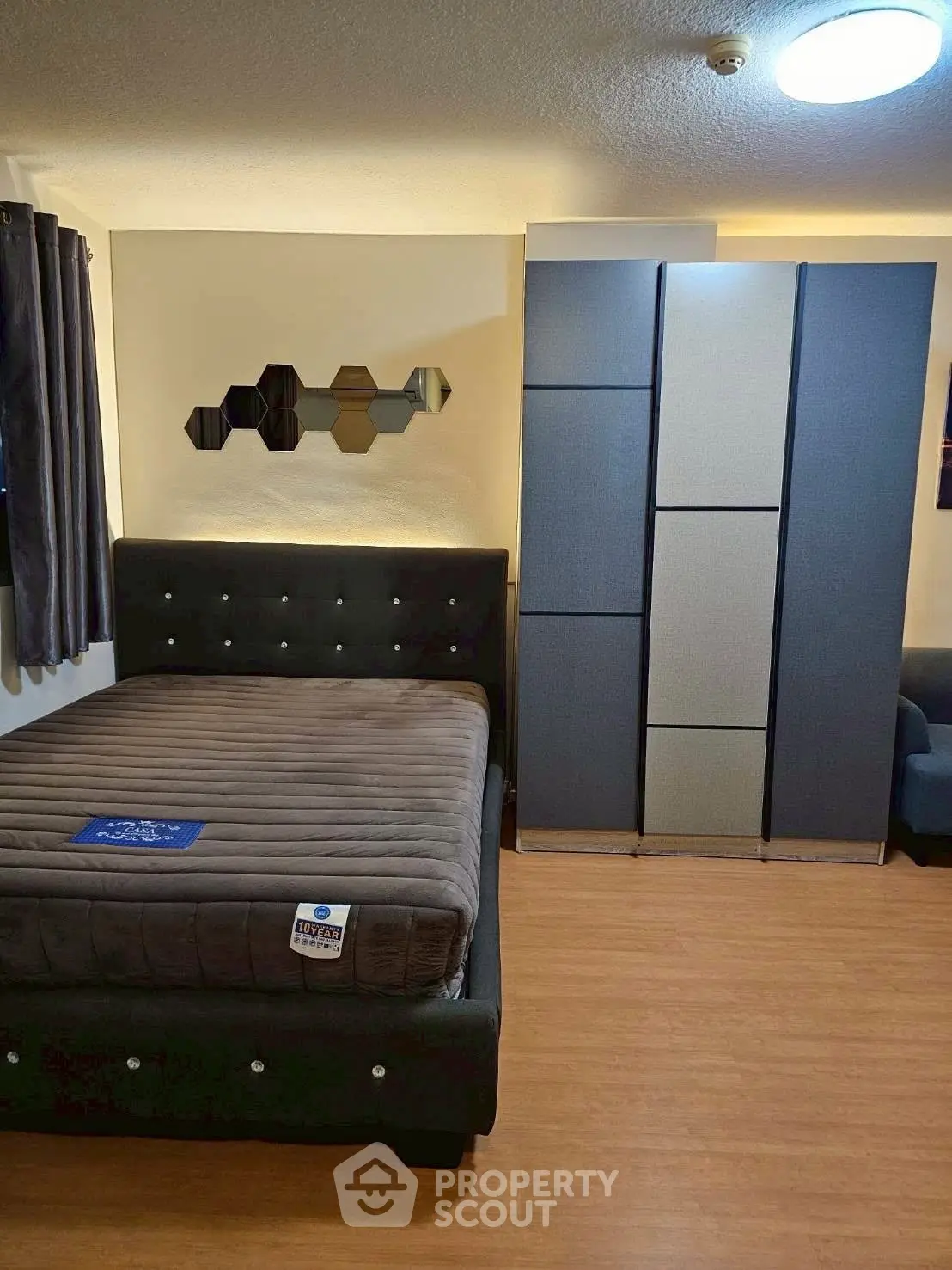 Modern bedroom with stylish bed and sleek wardrobe in cozy apartment