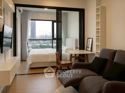 Modern studio apartment with stunning city view, featuring cozy living area and elegant bedroom.