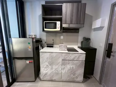 Modern compact kitchen with sleek appliances and stylish cabinetry
