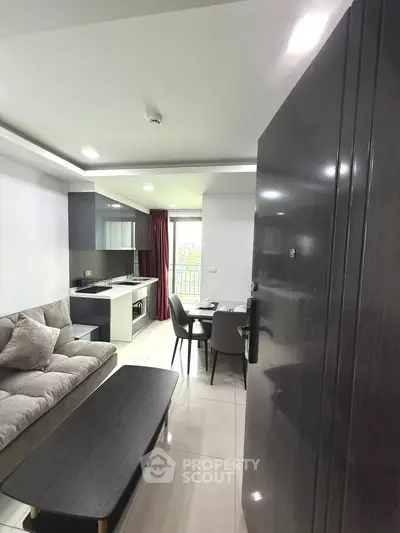 Modern open layout living room with sleek kitchen and cozy dining area