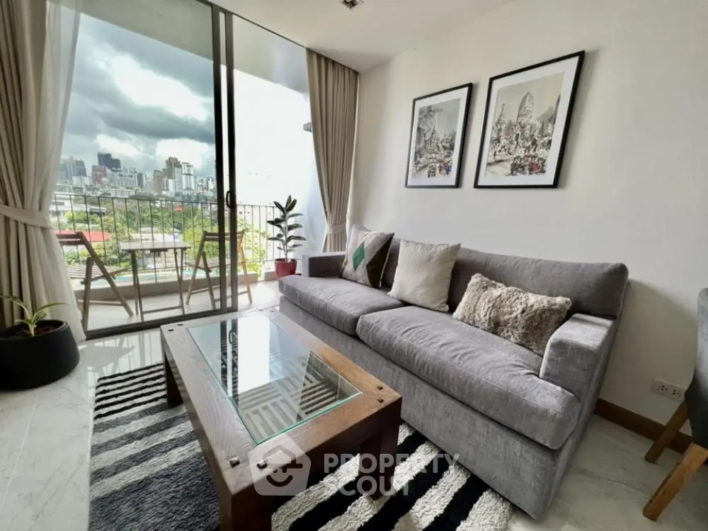 Stylish living room with city view and balcony access, featuring modern decor and comfortable seating.