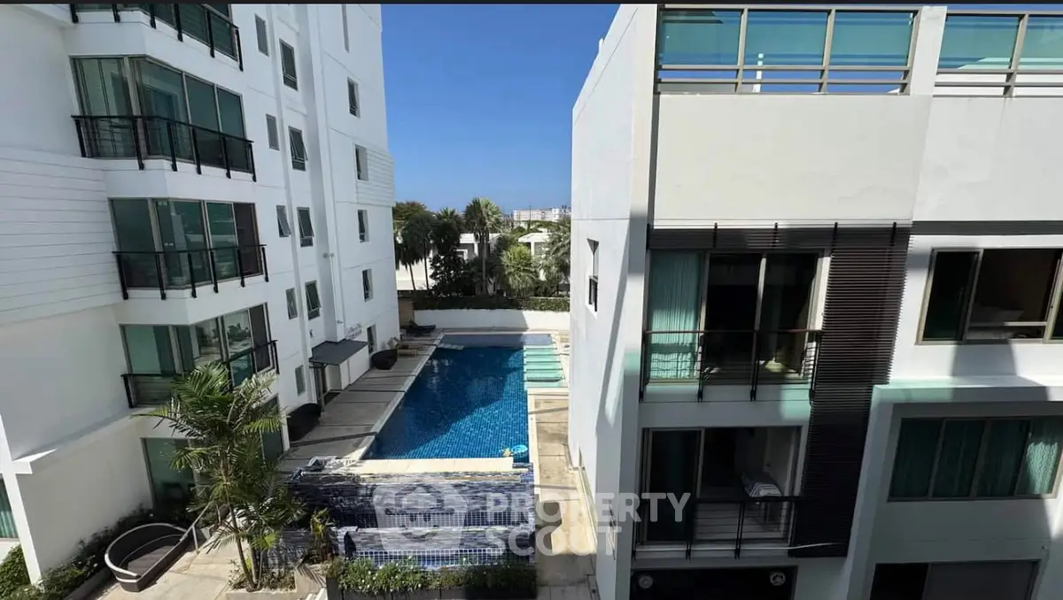 Modern apartment complex with pool view and balconies, ideal for luxury living.