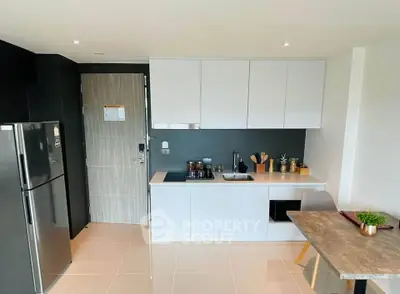 Modern kitchen with sleek cabinetry and integrated appliances in a stylish apartment.