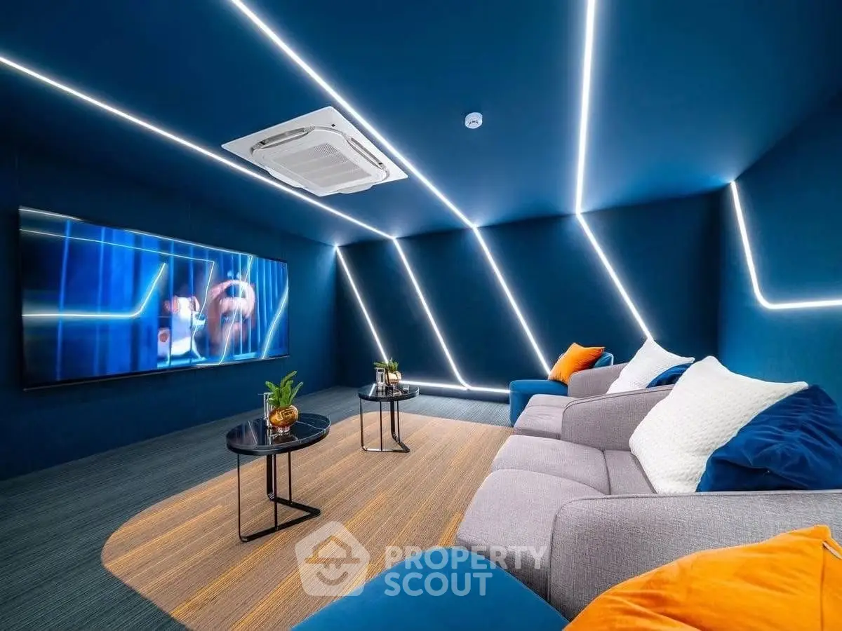 Modern living room with sleek blue design, LED lighting, and cozy seating for ultimate relaxation.