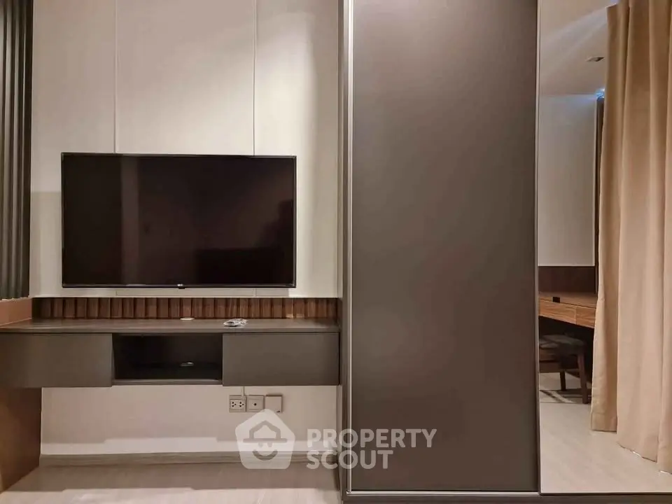 Modern living room with sleek TV setup and stylish furniture, perfect for contemporary living.
