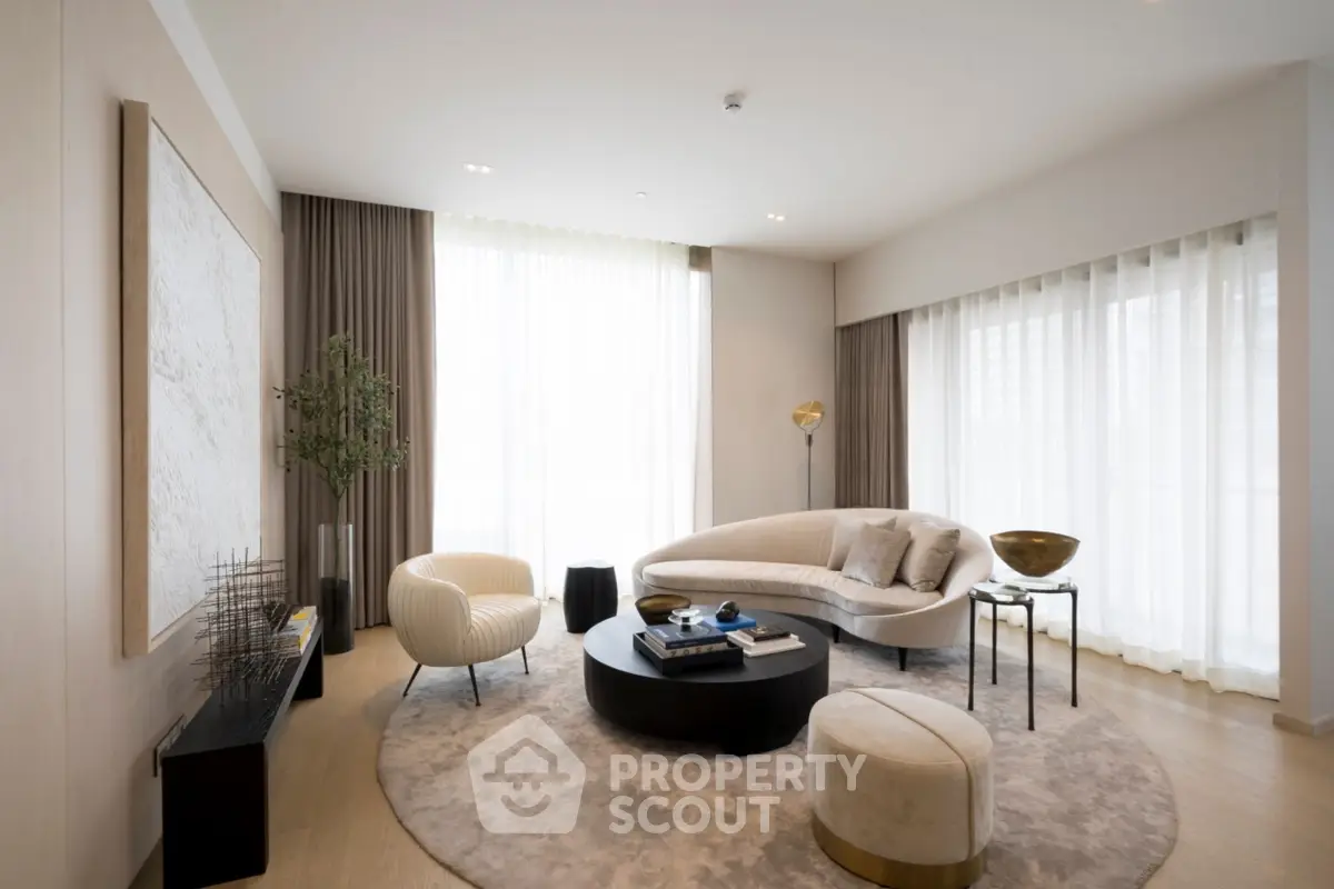 Luxurious modern living room with elegant furniture and large windows