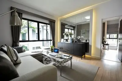 Modern living room with sleek design and large windows offering natural light.