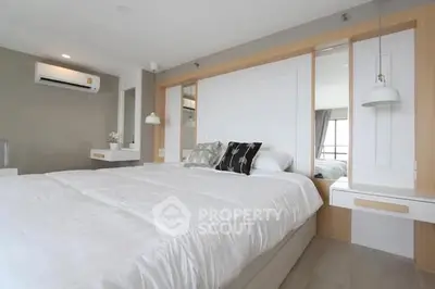 Modern bedroom with stylish decor and ample natural light