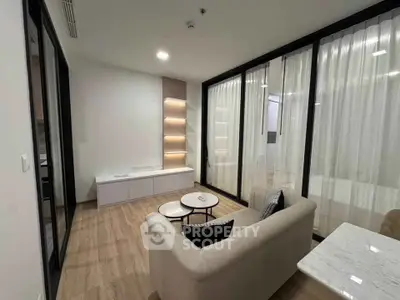 Modern living room with sleek design and cozy ambiance, featuring elegant furniture and stylish lighting.