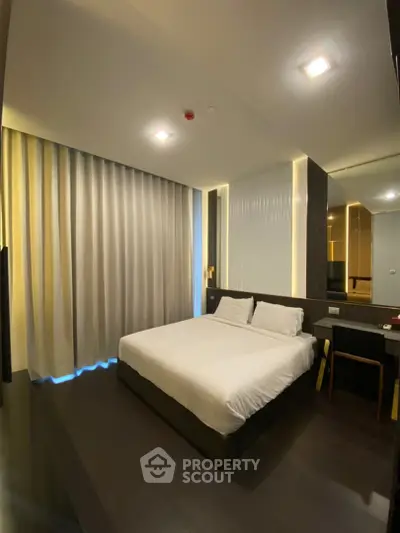 Modern bedroom with sleek design and ambient lighting, featuring a comfortable bed and stylish decor.