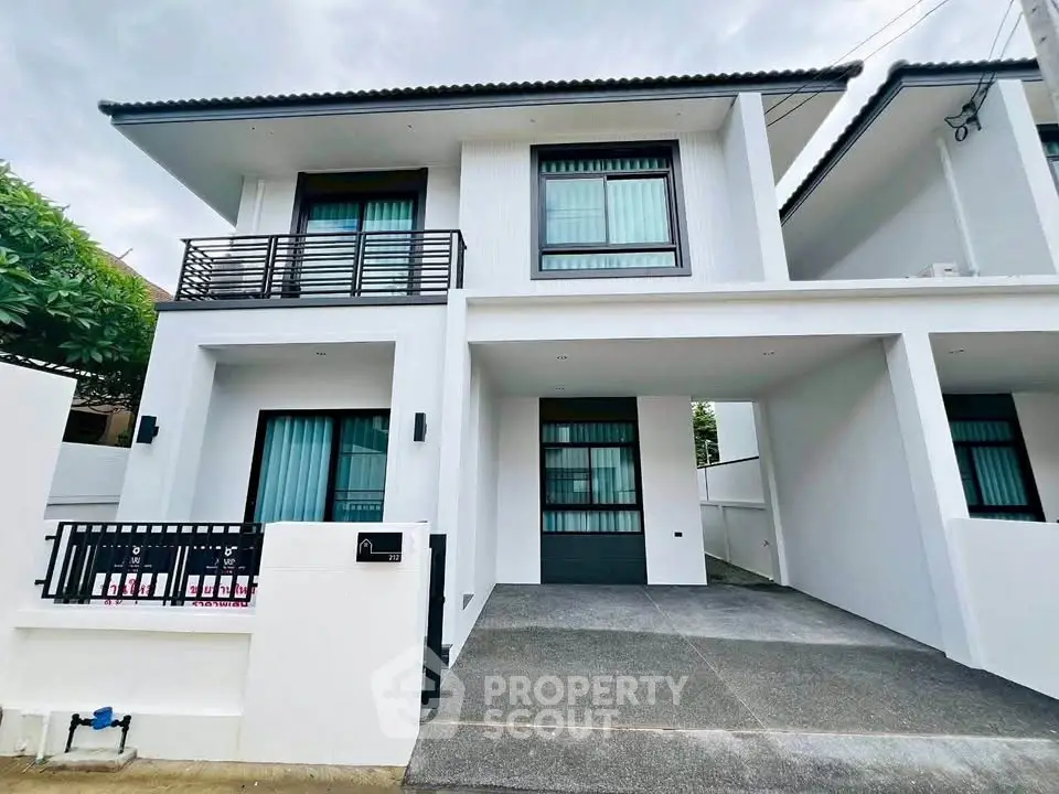 Modern two-story house with sleek design and spacious driveway in a serene neighborhood.