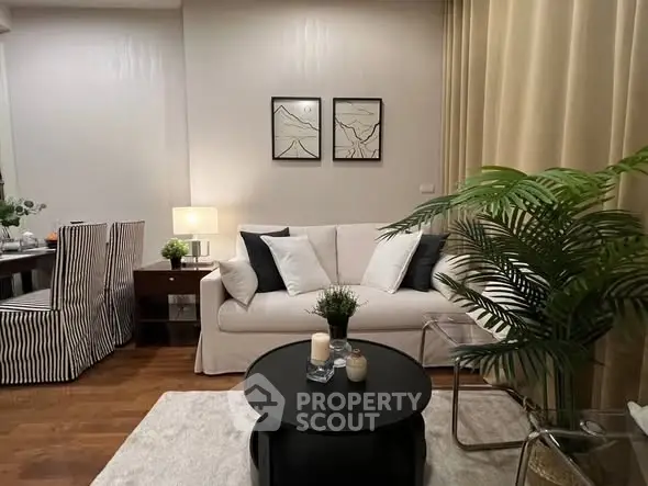 Stylish living room with cozy sofa, elegant decor, and warm lighting for a welcoming ambiance.