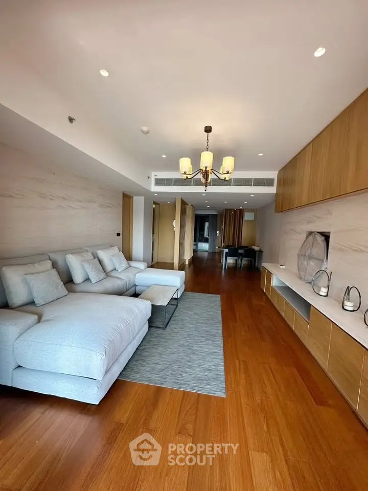 Spacious modern living room with elegant wooden flooring and stylish furniture