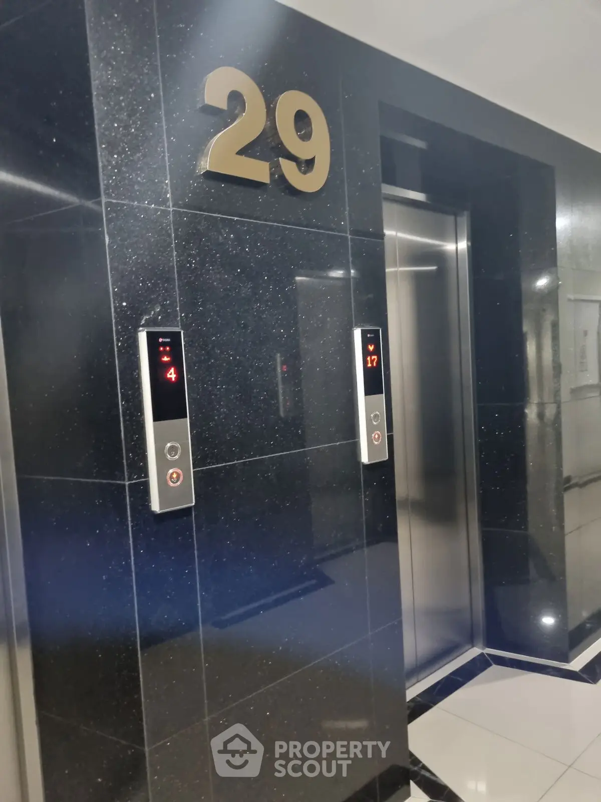 Modern high-rise building elevator lobby on the 29th floor with sleek design.