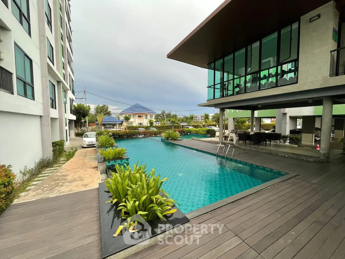 Luxurious modern apartment complex with stunning pool and lush greenery