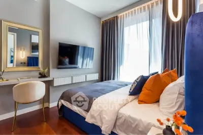 Modern bedroom with stylish decor, large window, and wall-mounted TV.