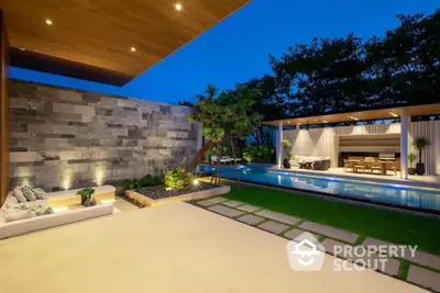 Luxurious modern outdoor patio with pool and garden at twilight