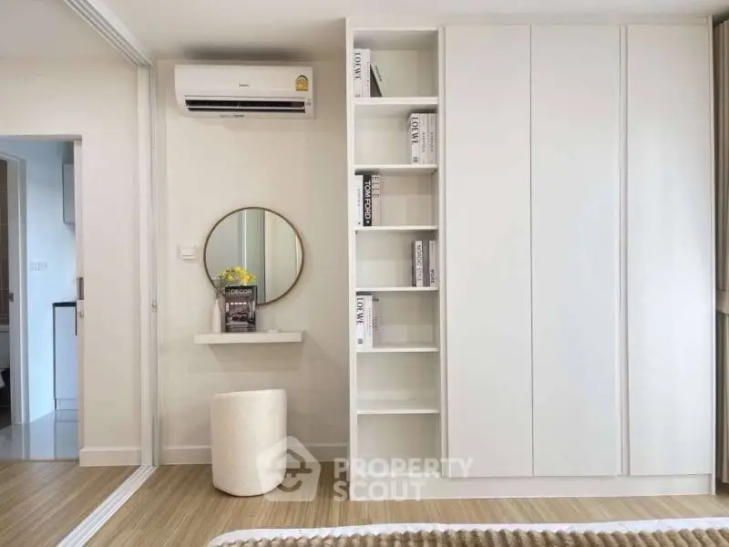 Modern bedroom with sleek white wardrobe and stylish decor