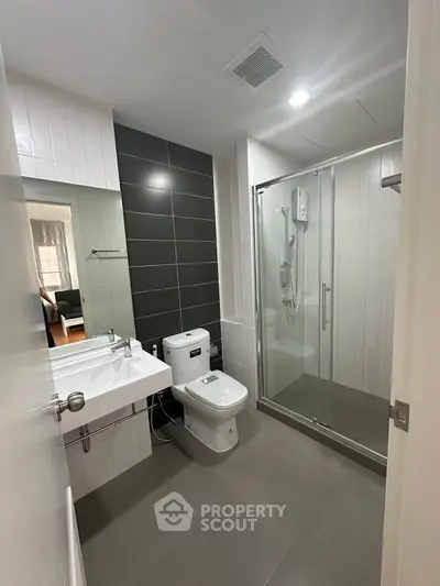 Modern bathroom with sleek design, glass shower, and contemporary fixtures.