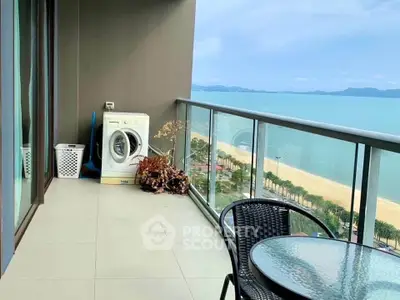 Stunning beachfront balcony with washer and seating, offering panoramic ocean views.