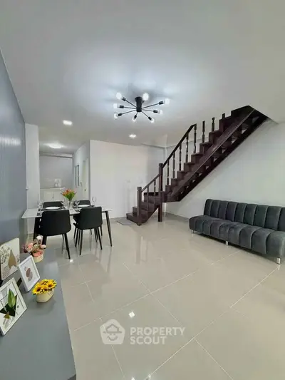 Modern living room with sleek staircase and stylish furniture