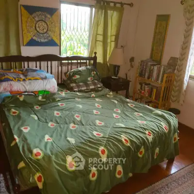 Cozy bedroom with avocado-themed bedding and natural light