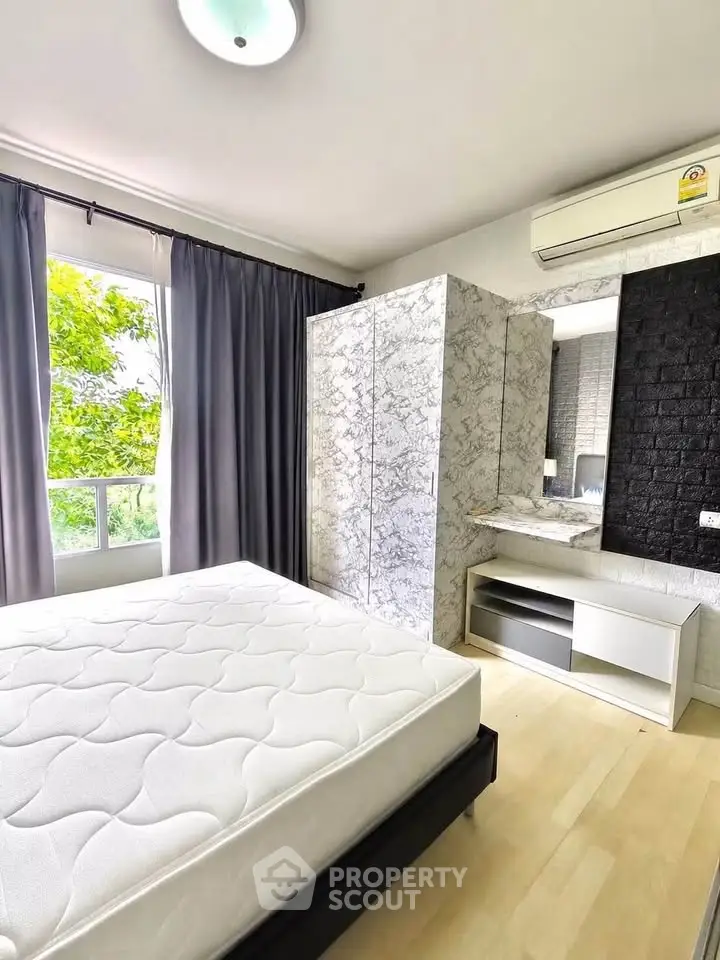 Modern bedroom with large window, stylish wardrobe, and air conditioning unit.